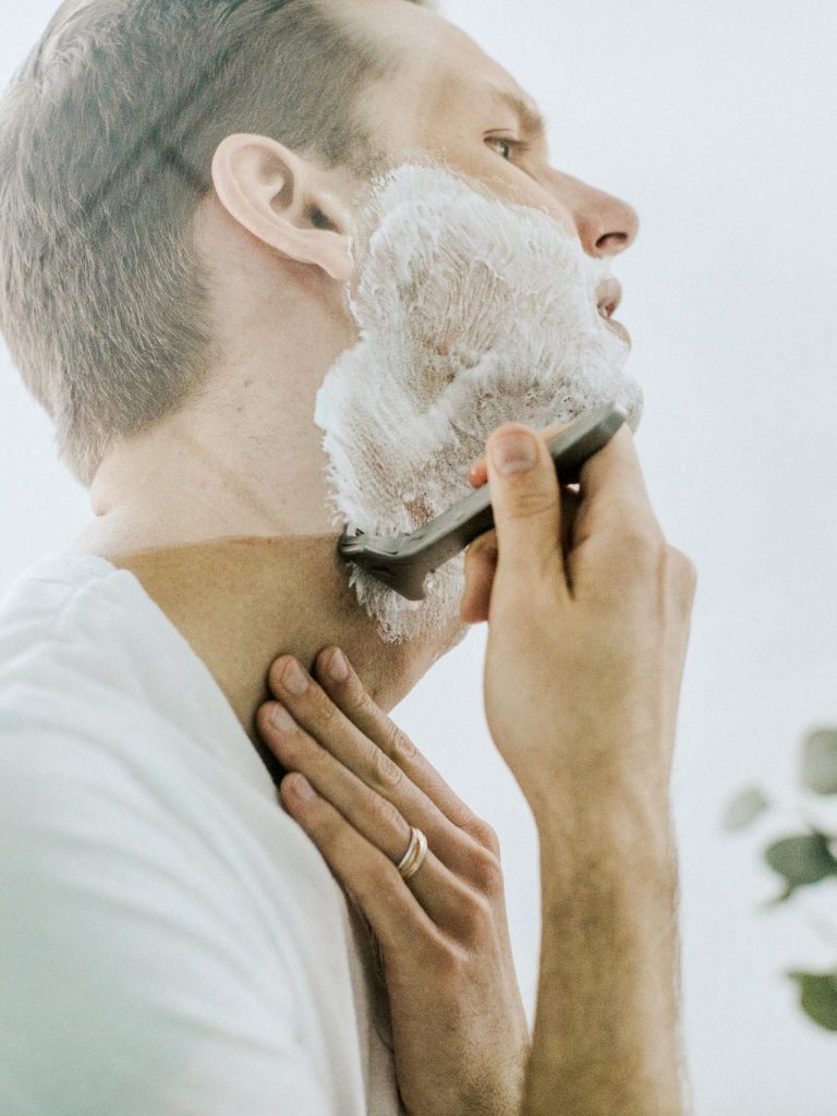 man shaving his beard