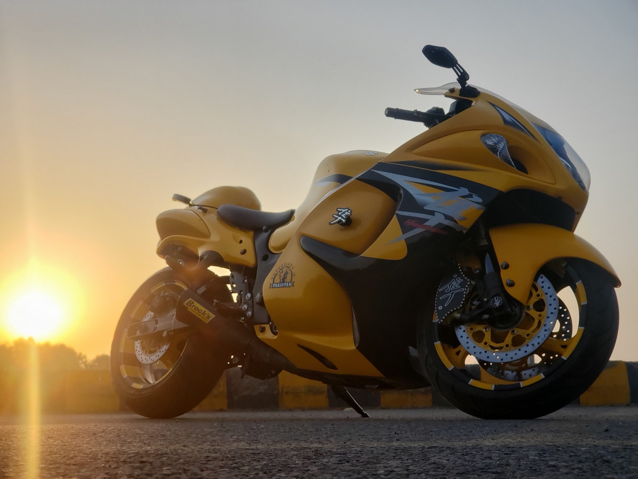 yellow and black sports bike on brown sand during sunset