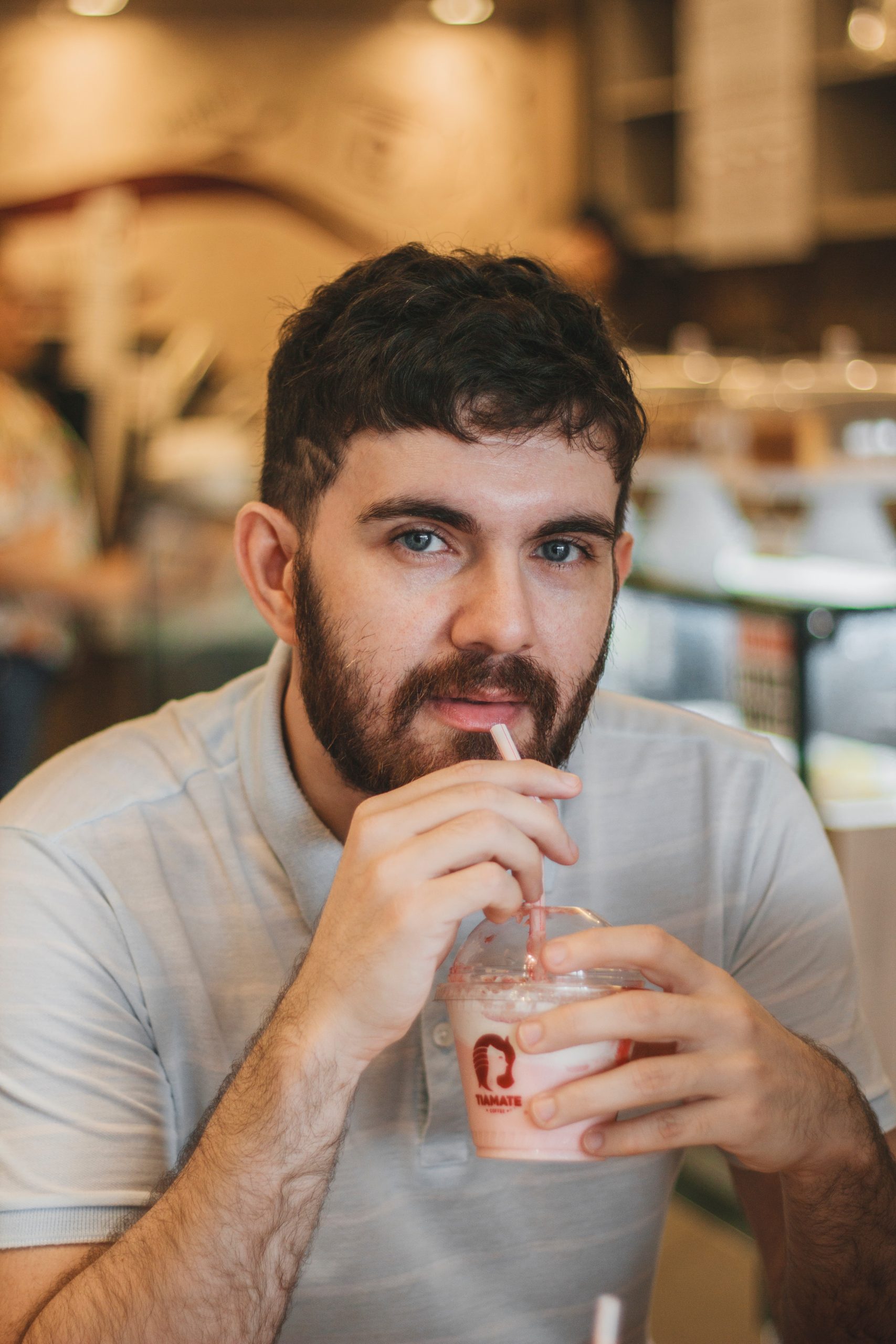 selective focus photography of man drinking smoothie